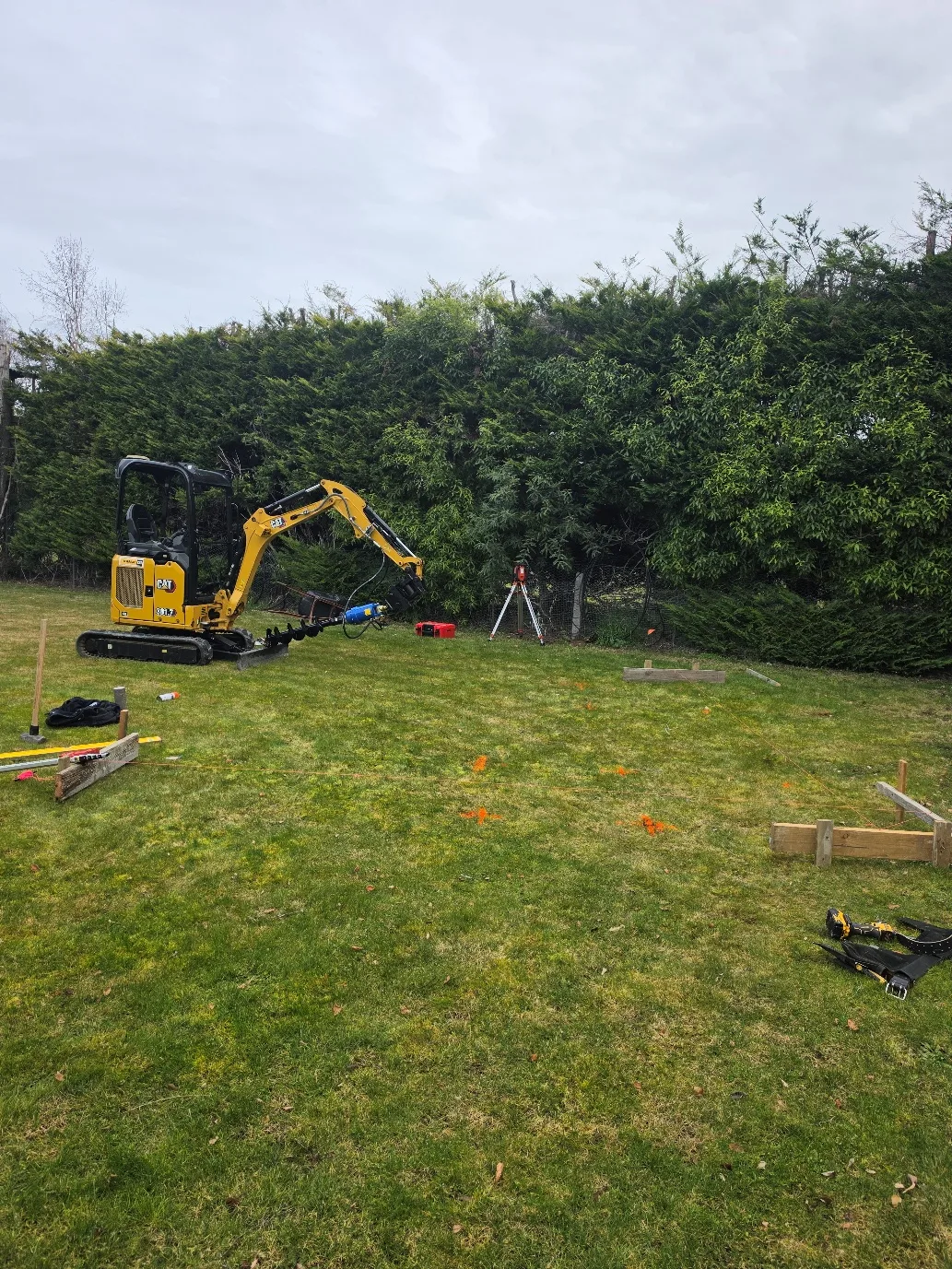 Mini excavator with auger during site preparation at 25 Derbridge Street