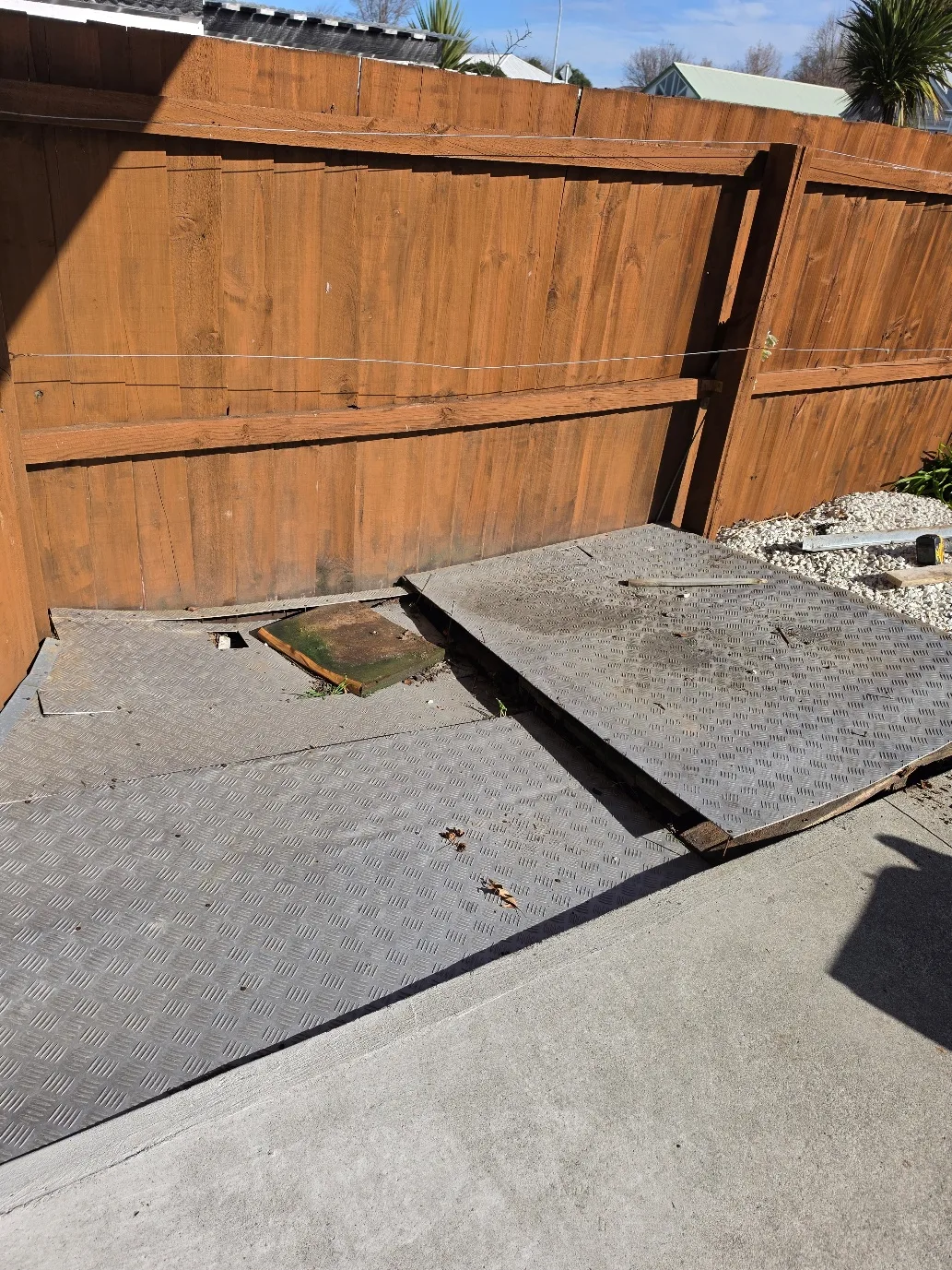 Bin storage area with checker plate and timber screening at 25 Derbridge Street, Christchurch
