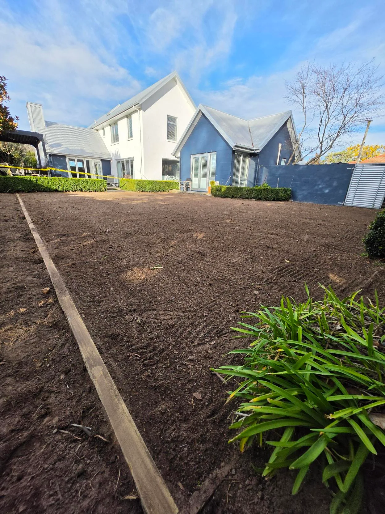 Large backyard area with freshly levelled and raked soil prepared for lawn sowing, Canterbury