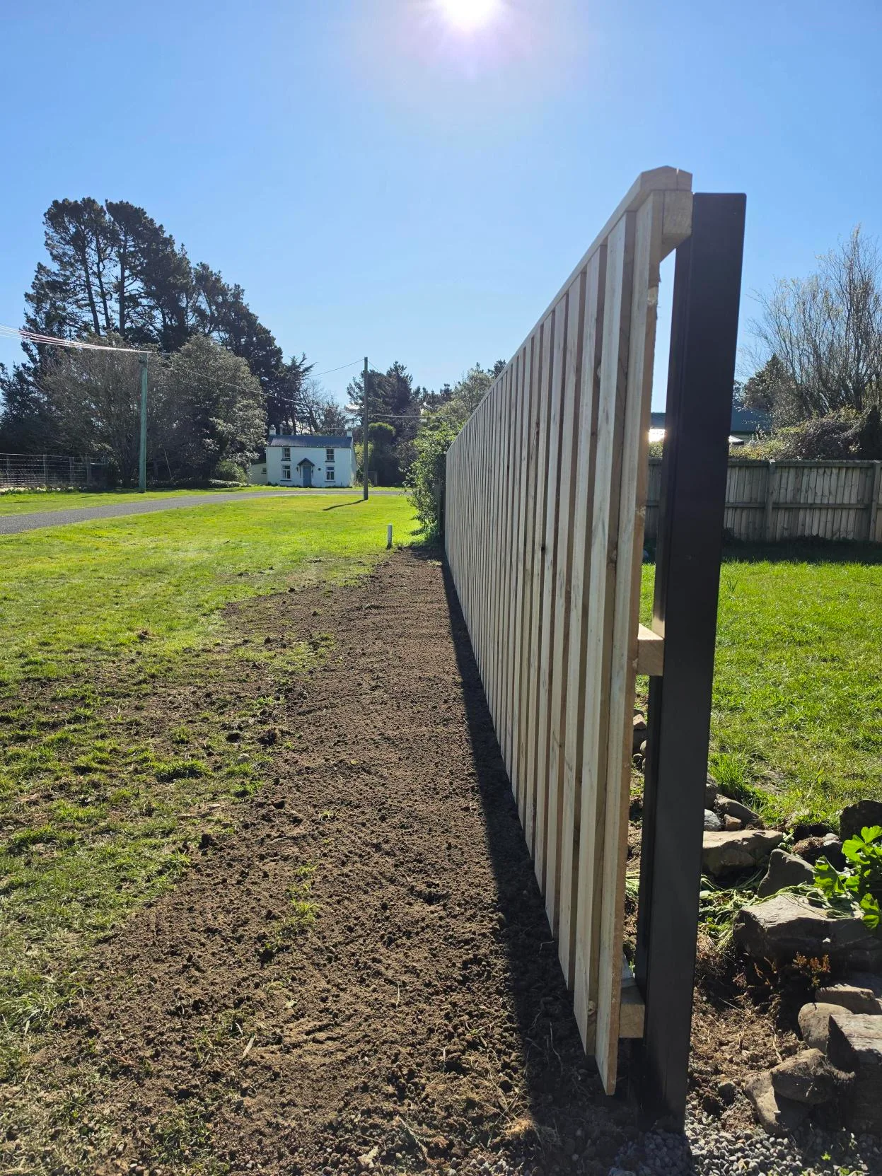 Straight timber boundary fencing with metal posts and fresh soil preparation at Waddington, Canterbury